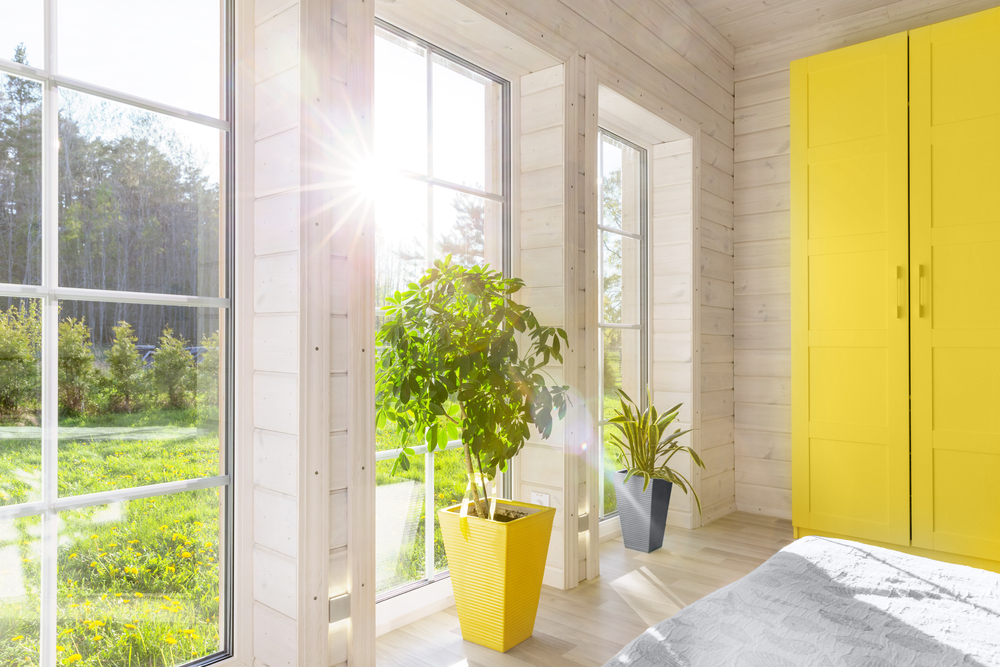 bright interior room in wooden house with large window