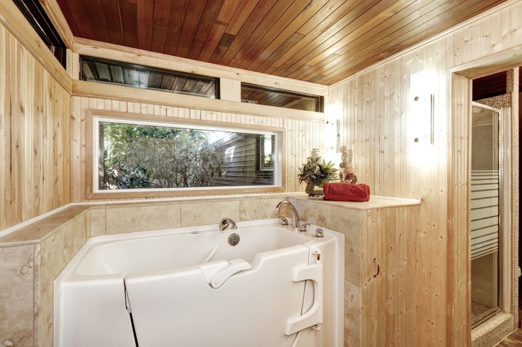 white walk-in bathtub in wood bathroom