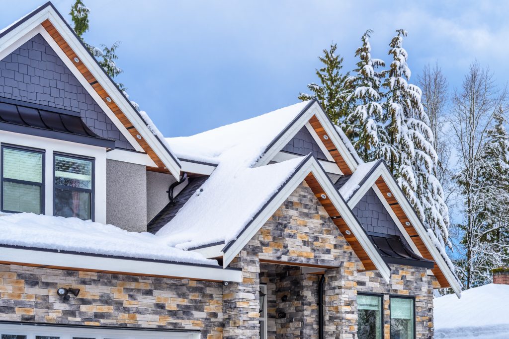 the top of a home in winter with snow