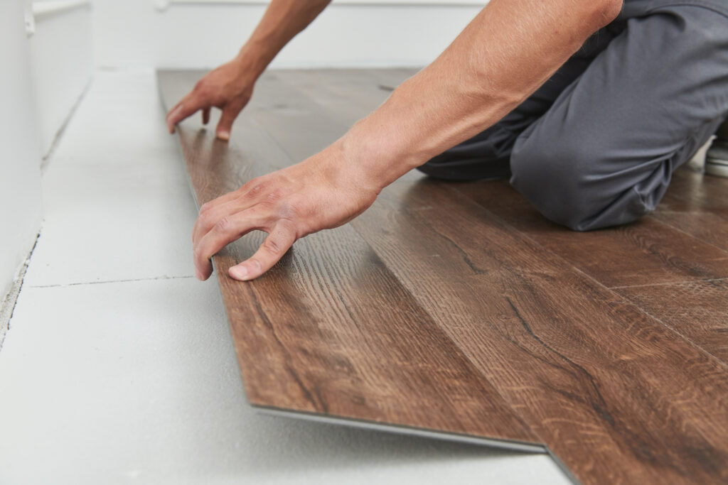 worker covering vinyl flooring at home