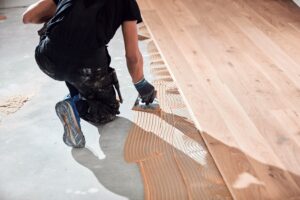 professional handyman installing flooring in a new apartment