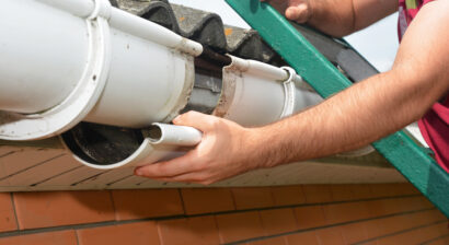 roofer making gutter repairs