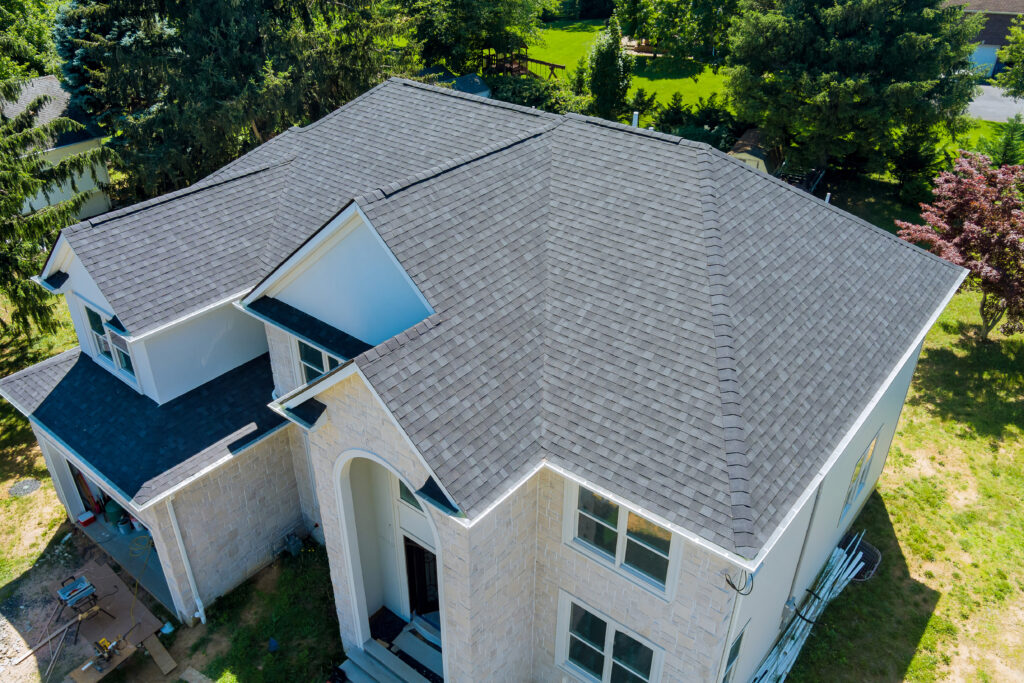 aerial view of residential home with asphalt roof