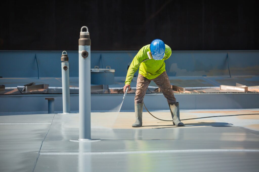 male worker holding an industrial spray gun