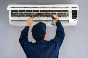 An HVAC pro conducting a comprehensive HVAC repair on a unit.