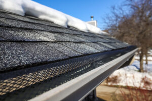 An image of gutters for a residential home with snow on the roof
