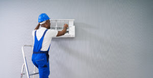 An HVAC technician conducting a diagnostic check on a residential HVAC unit as part of a repair