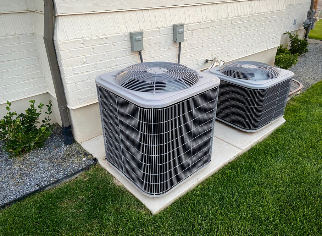 Two residential HVAC units installed side by side