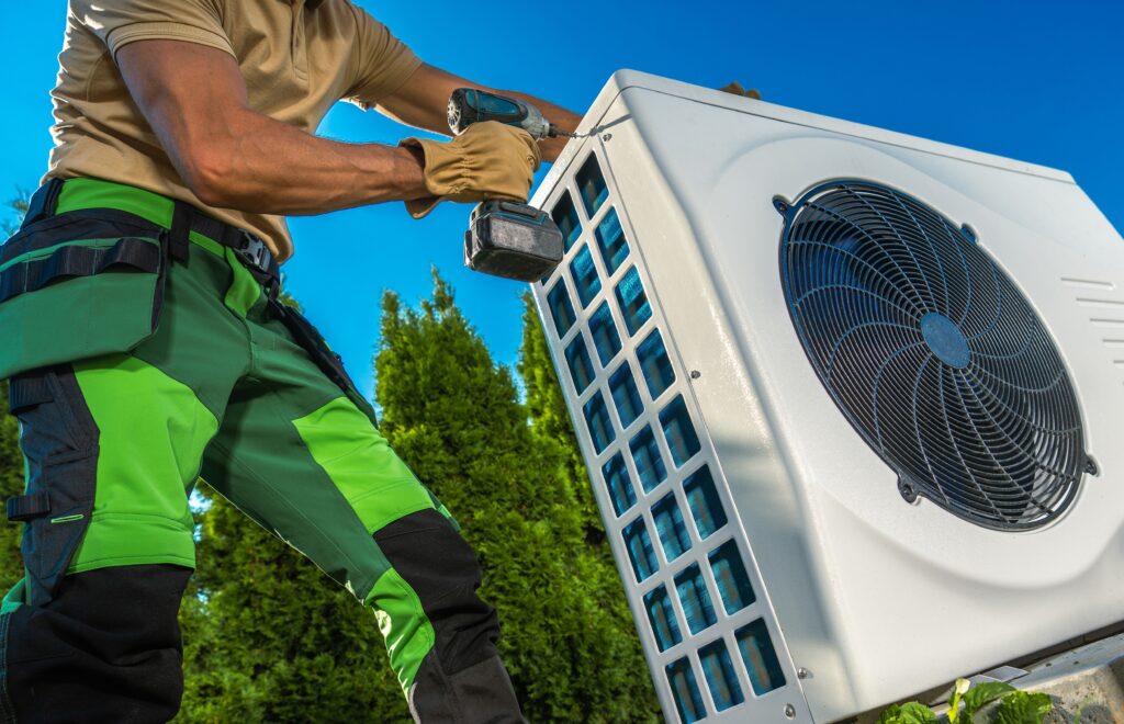 caucasian professional hvac technician installing heat pump