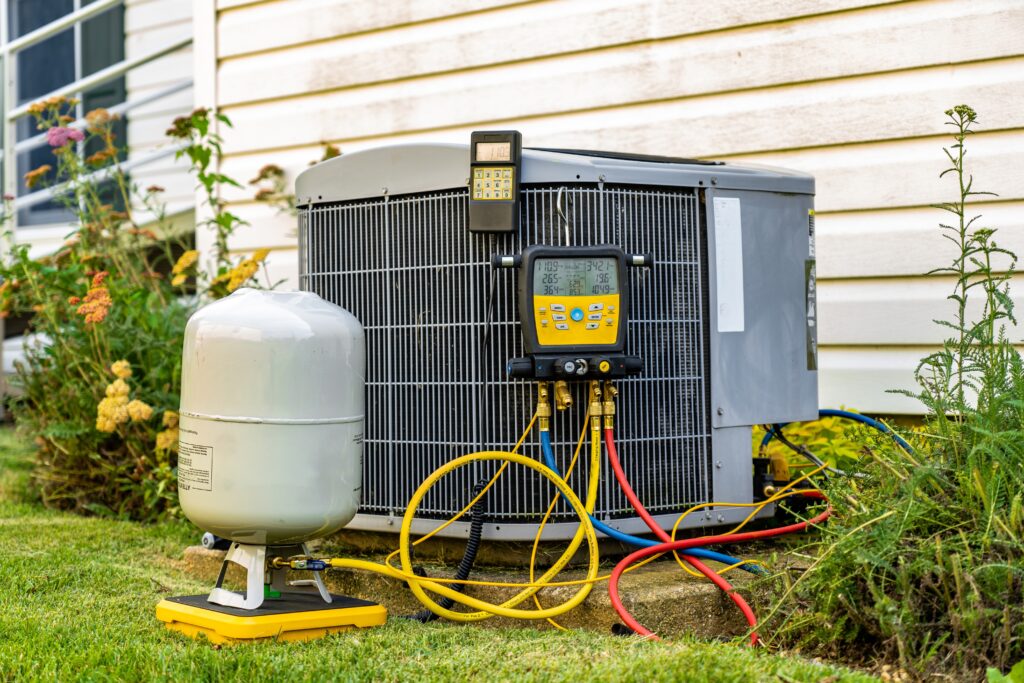 An HVAC unit with diagnostic equipment attached to it in preparation for a diagnosis from an HVAC technician