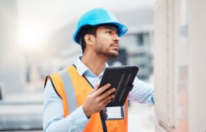 An HVAC professional examining an HVAC unit