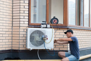 hvac technician installs outdoor unit