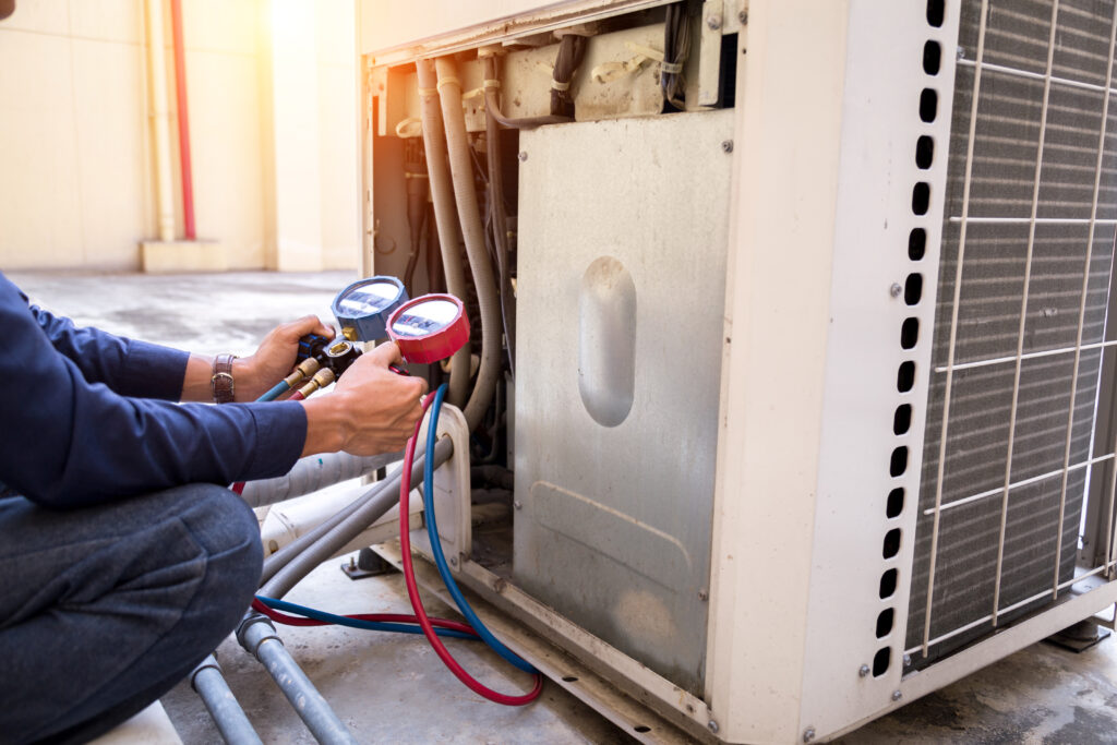 technician checking ac measuring equipment