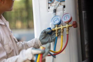 close up view of ac technician repairing ac unit