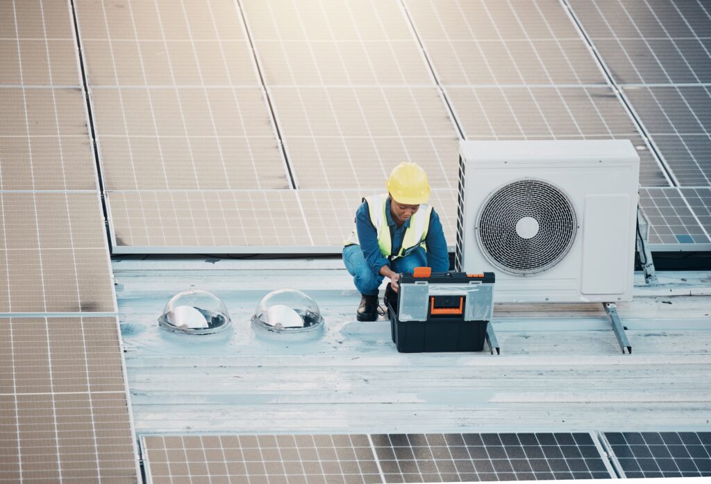 ac technician on roof with ac unit and solar