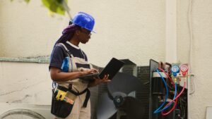 female technician servicing outdoor hvac unit