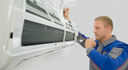 young male technician repairing an hvac unit