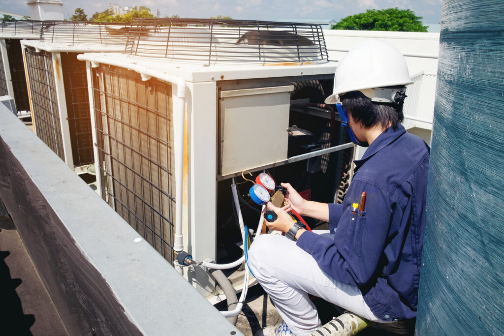 technician inspecting ac unit