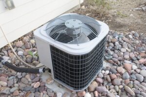 residential air conditioning unit on stones