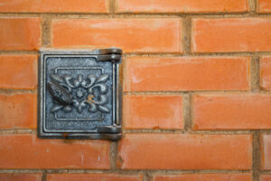 iron lid of the furnace against a brick wall