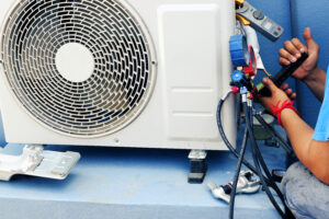 ac technician repairing leakage in unit
