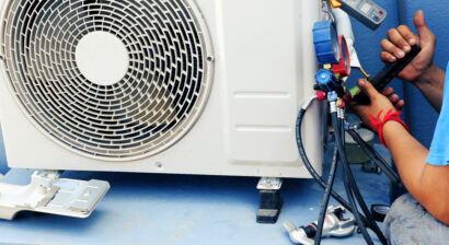 ac technician repairing leakage in unit