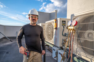 hvac technician standing next to ductless mini split