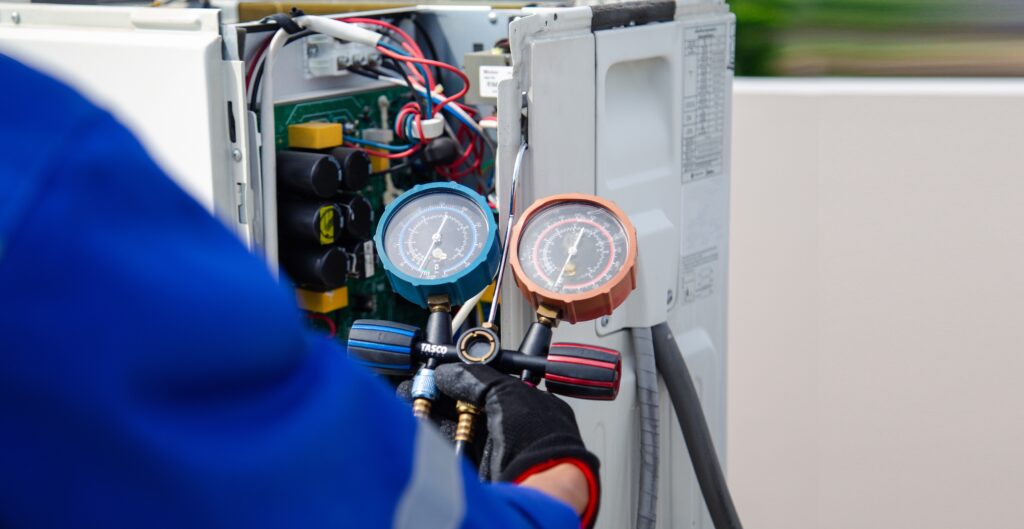 ac technician checking refrigerant