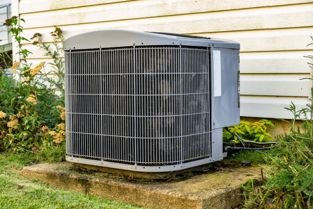 an ac unit sitting on a concrete pad