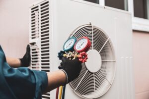 hvac technician measuring levels of unit