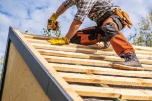 man working on roof elements