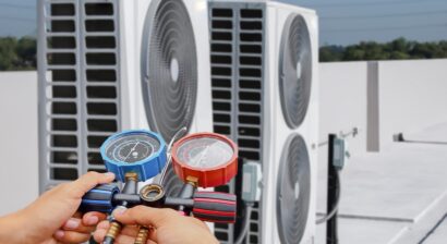 hvac technician using gauges to check refrigerant