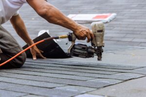nail gun used by roofer to install new roof