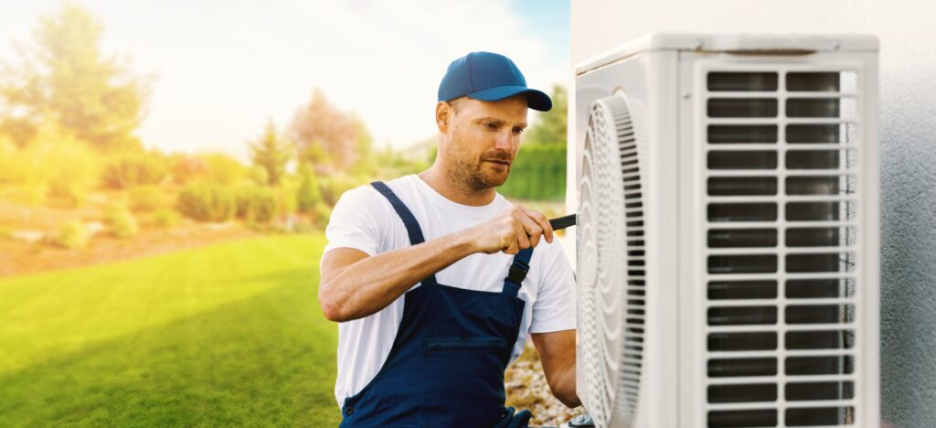 technician working on air conditioning unit of residential home