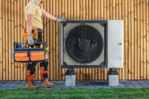 hvac technician standing next to an installed unit