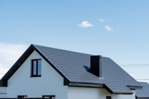 a house with white siding and a black roof