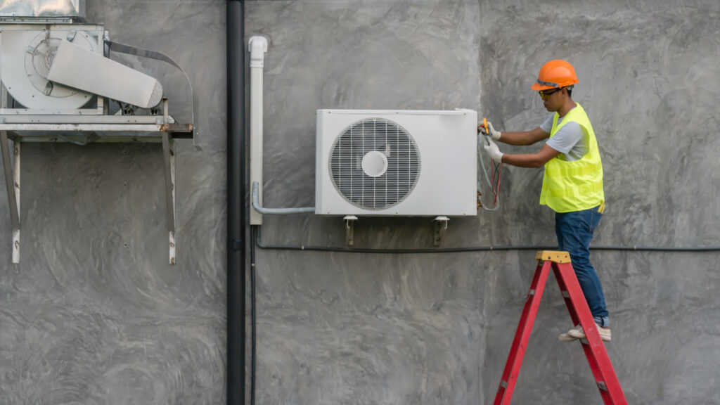 technician checking outdoor ac unit