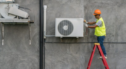 technician checking outdoor ac unit