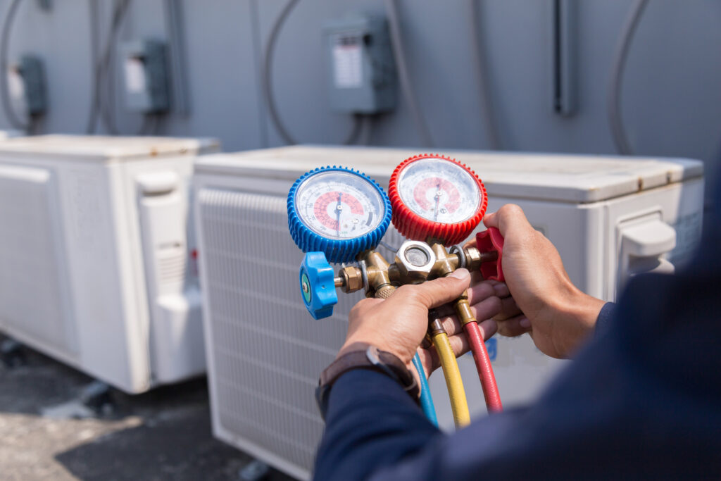 technician checking air conditioning unit