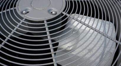residential ac unit outdoors with fan and coils