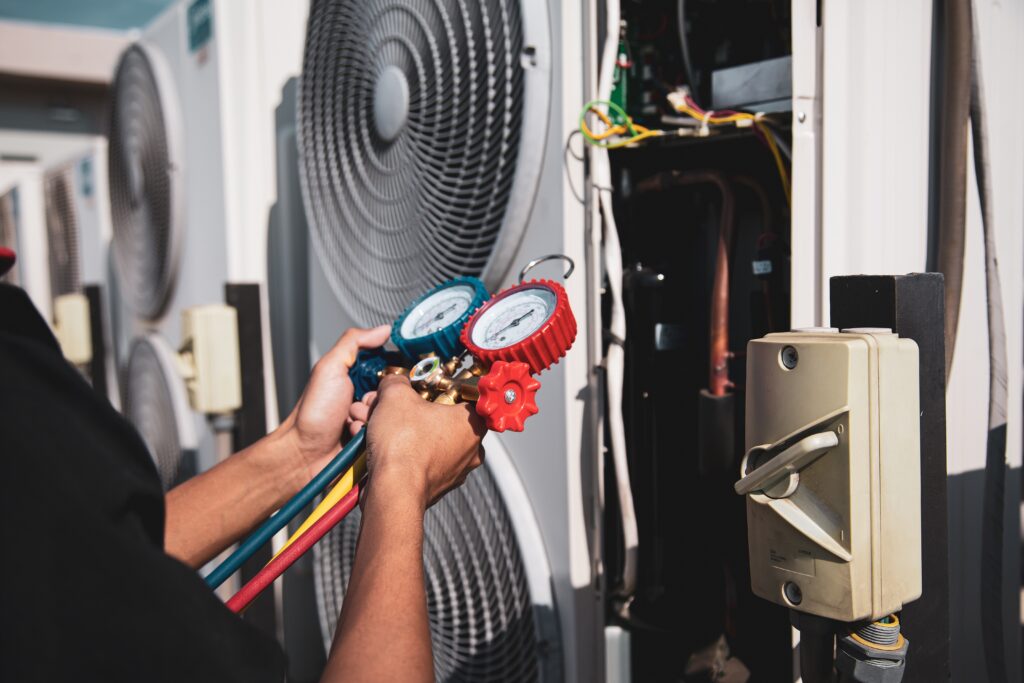 hvac technician measuring on a unit