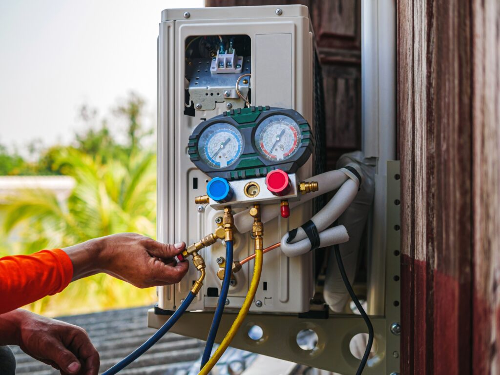 ac technician installs new compressor using measuring tool