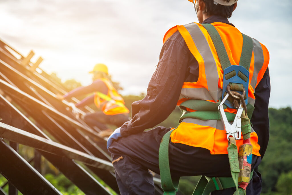 contruction worker on roof in safety gear