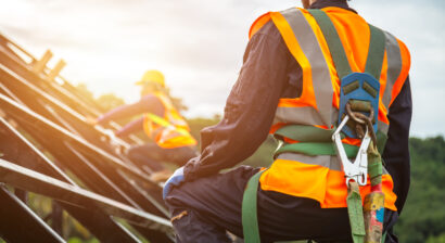 contruction worker on roof in safety gear