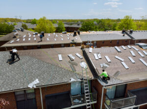 construction workers on the roof of a house for a renovation