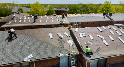 construction workers on the roof of a house for a renovation