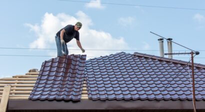 workers install metal roofing