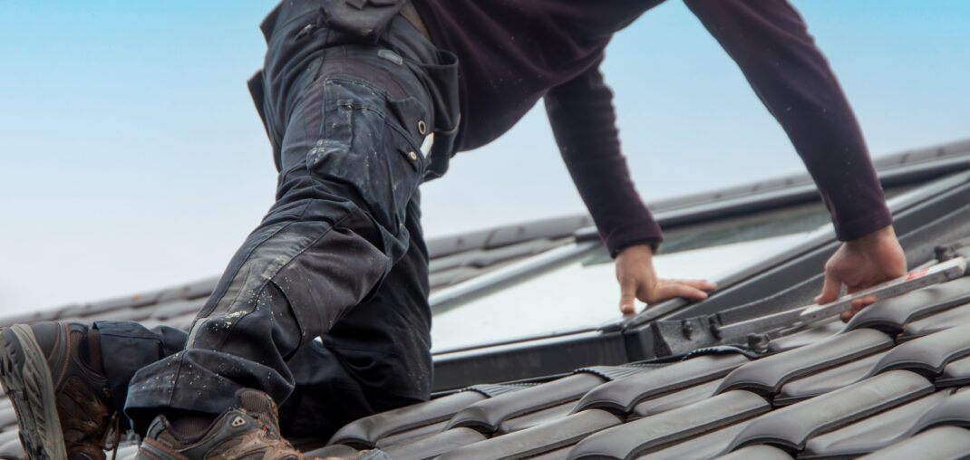 roofer installing a new roof window