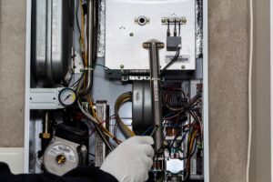 technician fixing a central heating issue