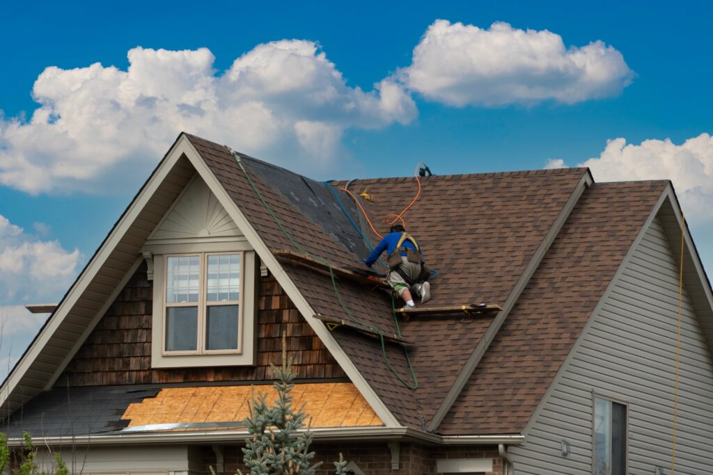 a worker moving along roof for next repair